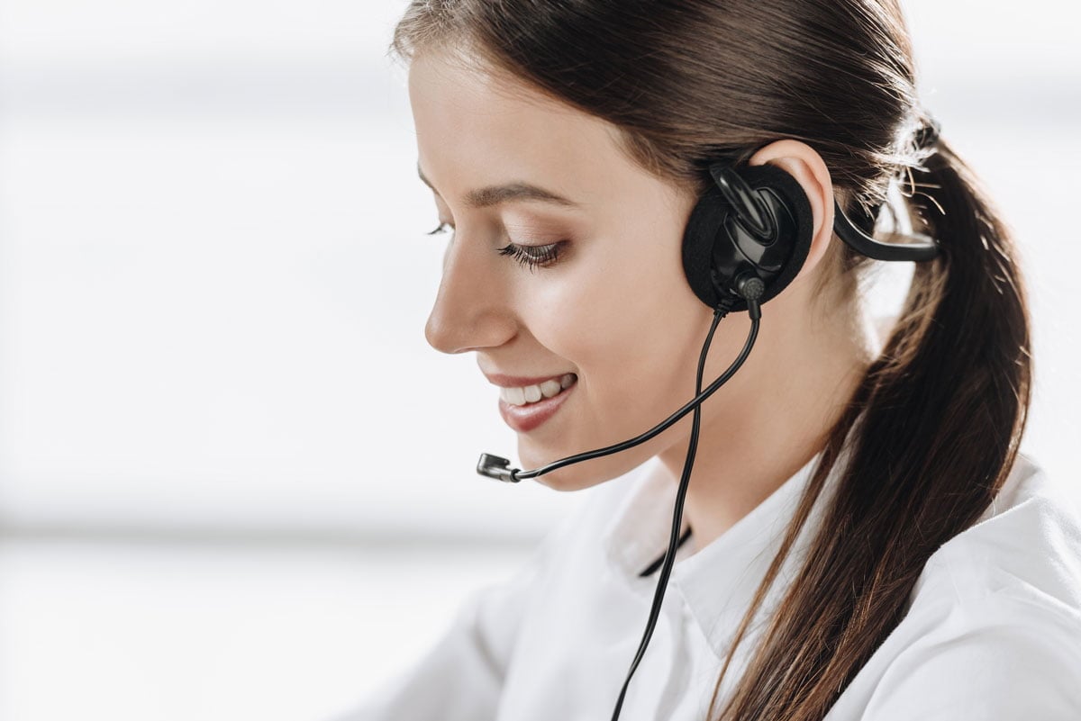 beautiful female call center worker with headphone M7JAAED